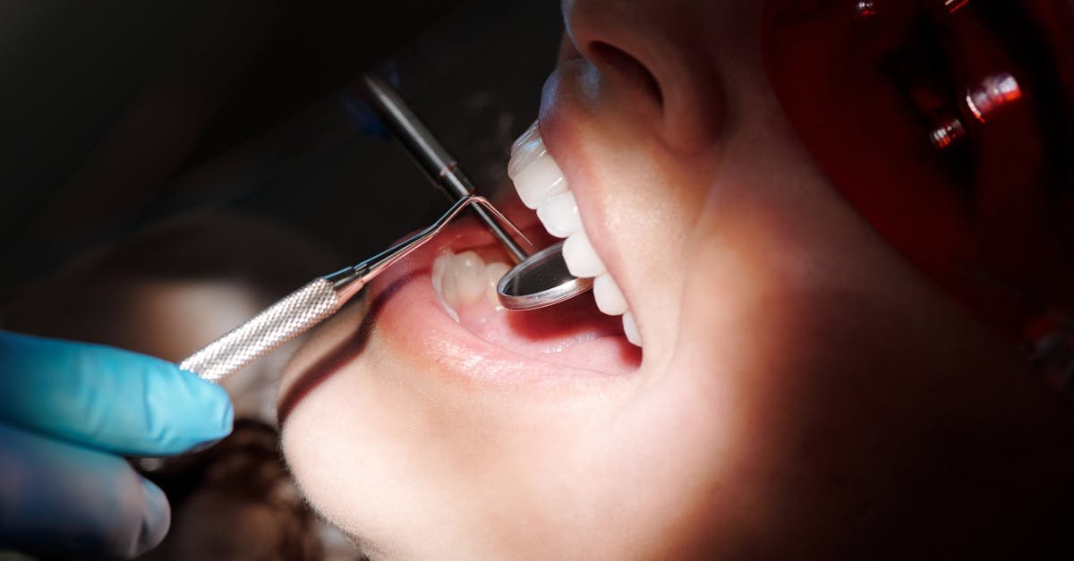 Detailed image of a dental check-up showing tools and patient wearing protective eyewear.